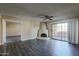 Cozy living room with a unique fireplace and access to a balcony through sliding glass doors at 10410 N Cave Creek Rd # 2220, Phoenix, AZ 85020