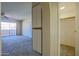 Cozy living room featuring an outdoor view, pantry, and access to a closet and additional rooms at 10410 N Cave Creek Rd # 2220, Phoenix, AZ 85020