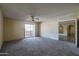 Comfortable living room with neutral walls, carpeting, a ceiling fan, and sliding doors to a balcony or patio at 10410 N Cave Creek Rd # 2220, Phoenix, AZ 85020