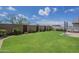 A well-maintained backyard features lush green grass, mature landscaping, and a patio area at 10509 W Harmony Ln, Peoria, AZ 85382