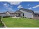 Well-maintained backyard with lush green grass, patio furniture, and a covered patio area at 10509 W Harmony Ln, Peoria, AZ 85382
