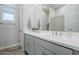 Bathroom features a dual sink vanity, framed mirror, and neutral wall paint at 10509 W Harmony Ln, Peoria, AZ 85382