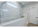 Sleek bathroom features frameless shower, marble-look tiles, and modern fixtures at 10509 W Harmony Ln, Peoria, AZ 85382