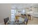 Bright dining area adjacent to a modern kitchen and spacious living room at 10509 W Harmony Ln, Peoria, AZ 85382