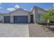 Beautiful single-Gathering home featuring stone accents, paver driveway, and a modern garage door at 10509 W Harmony Ln, Peoria, AZ 85382