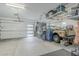 A well-organized garage interior featuring storage racks and space for vehicles at 10509 W Harmony Ln, Peoria, AZ 85382