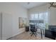Well-lit home office with large monitors, wooden desk, and carpeted flooring at 10509 W Harmony Ln, Peoria, AZ 85382