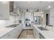 Bright, open kitchen with white cabinets, stainless steel appliances, and modern countertops at 10509 W Harmony Ln, Peoria, AZ 85382