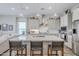 Open-concept kitchen with a large island, modern appliances, and pendant lighting at 10509 W Harmony Ln, Peoria, AZ 85382