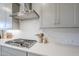 Close-up of a modern kitchen featuring white countertops, cabinetry, and stainless steel appliances at 10509 W Harmony Ln, Peoria, AZ 85382