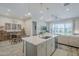 Spacious kitchen island with seating, overlooking dining and living areas at 10509 W Harmony Ln, Peoria, AZ 85382