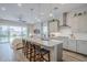 Bright and airy kitchen with a large island, pendant lights, and an open view to the living area at 10509 W Harmony Ln, Peoria, AZ 85382