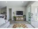 Inviting living room featuring a decorative cabinet, entertainment center, and seamless indoor-outdoor flow at 10509 W Harmony Ln, Peoria, AZ 85382