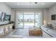 Cozy living space with an entertainment center and large glass doors offering views of the backyard at 10509 W Harmony Ln, Peoria, AZ 85382