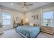 Serene primary bedroom with a ceiling fan, soft natural light, and soothing color palette at 10509 W Harmony Ln, Peoria, AZ 85382