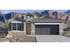 Charming single-story home showcasing desert landscaping, a two-car garage and shutters at 10516 W Bloch Rd, Tolleson, AZ 85353