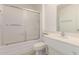 Bathroom featuring a vanity, toilet, and tub with shower and sliding glass doors at 10724 W Cheryl Dr, Sun City, AZ 85351