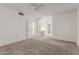 Large bedroom with a ceiling fan, carpeted floors, and lots of space at 10724 W Cheryl Dr, Sun City, AZ 85351