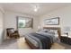 Cozy bedroom featuring a ceiling fan and a comfortable chair by the window at 10724 W Cheryl Dr, Sun City, AZ 85351