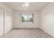 Bright bedroom features neutral carpet, a ceiling fan, a window and a closet at 10724 W Cheryl Dr, Sun City, AZ 85351