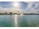Vast lake with fountain centerpiece, framed by palm trees and distant buildings under a sunny sky at 10724 W Cheryl Dr, Sun City, AZ 85351