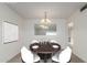 Dining room with round table and four white chairs; neutrally painted room at 10724 W Cheryl Dr, Sun City, AZ 85351
