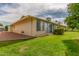 Exterior view of the backyard featuring a lush green lawn and mature trees at 10724 W Cheryl Dr, Sun City, AZ 85351