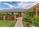 Inviting front entrance with tiled walkway, garden bed, and security door at 10724 W Cheryl Dr, Sun City, AZ 85351