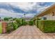 Charming home with brick accents and lush landscaping creates a welcoming curb appeal at 10724 W Cheryl Dr, Sun City, AZ 85351