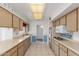 Classic kitchen with a garden window, tile floors and ample cabinet space at 10724 W Cheryl Dr, Sun City, AZ 85351