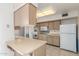 The kitchen features tile flooring, breakfast bar, and lots of storage at 10724 W Cheryl Dr, Sun City, AZ 85351