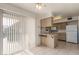 Eat-in kitchen featuring tile floor, breakfast bar and lots of light at 10724 W Cheryl Dr, Sun City, AZ 85351