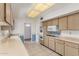 Well-maintained kitchen boasts lots of cabinets, updated appliances, and neutral walls at 10724 W Cheryl Dr, Sun City, AZ 85351