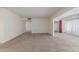 Spacious living room featuring neutral carpet, white walls, and ample natural light at 10724 W Cheryl Dr, Sun City, AZ 85351
