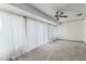 Spacious living room features neutral walls, plush carpeting, and natural lighting at 10724 W Cheryl Dr, Sun City, AZ 85351