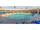 Large circular pool surrounded by lounge chairs and blue awnings in a resort-style setting at 10724 W Cheryl Dr, Sun City, AZ 85351