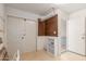 Storage room with white tiled floor and shelving; providing ample storage space at 10724 W Cheryl Dr, Sun City, AZ 85351
