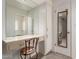 Bathroom vanity with a mirror, cabinets, a drawer, and a chair at 10724 W Cheryl Dr, Sun City, AZ 85351