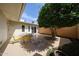 Private backyard patio with mature landscaping and ample seating space at 10827 W Santa Fe Dr, Sun City, AZ 85351
