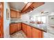 Home bar area complete with a granite countertop, wine rack, and wooden cabinets at 10827 W Santa Fe Dr, Sun City, AZ 85351