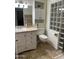 Bright bathroom featuring tile flooring, a sink, and a glass block shower wall at 10827 W Santa Fe Dr, Sun City, AZ 85351