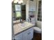 Bright bathroom features a white vanity and countertop with modern sink and chrome fixtures at 10827 W Santa Fe Dr, Sun City, AZ 85351