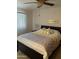Bedroom featuring a large window with blinds and stylish decor at 10827 W Santa Fe Dr, Sun City, AZ 85351