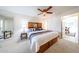 Bright bedroom with a large bed with storage, and closet at 10827 W Santa Fe Dr, Sun City, AZ 85351