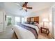 Bright bedroom with a large bed, ensuite bathroom, and closet at 10827 W Santa Fe Dr, Sun City, AZ 85351