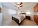 Cozy bedroom with carpet, large window, and wall cabinets at 10827 W Santa Fe Dr, Sun City, AZ 85351
