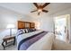 Bright bedroom with a large bed with storage, and closet at 10827 W Santa Fe Dr, Sun City, AZ 85351