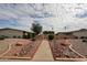 Charming community entrance with mature landscaping and well-maintained grounds at 10827 W Santa Fe Dr, Sun City, AZ 85351