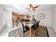 Dining area featuring a modern table, black chairs, and view of the kitchen at 10827 W Santa Fe Dr, Sun City, AZ 85351