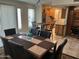 Open concept with sliding glass doors, modern ceiling fan, and view to updated kitchen at 10827 W Santa Fe Dr, Sun City, AZ 85351